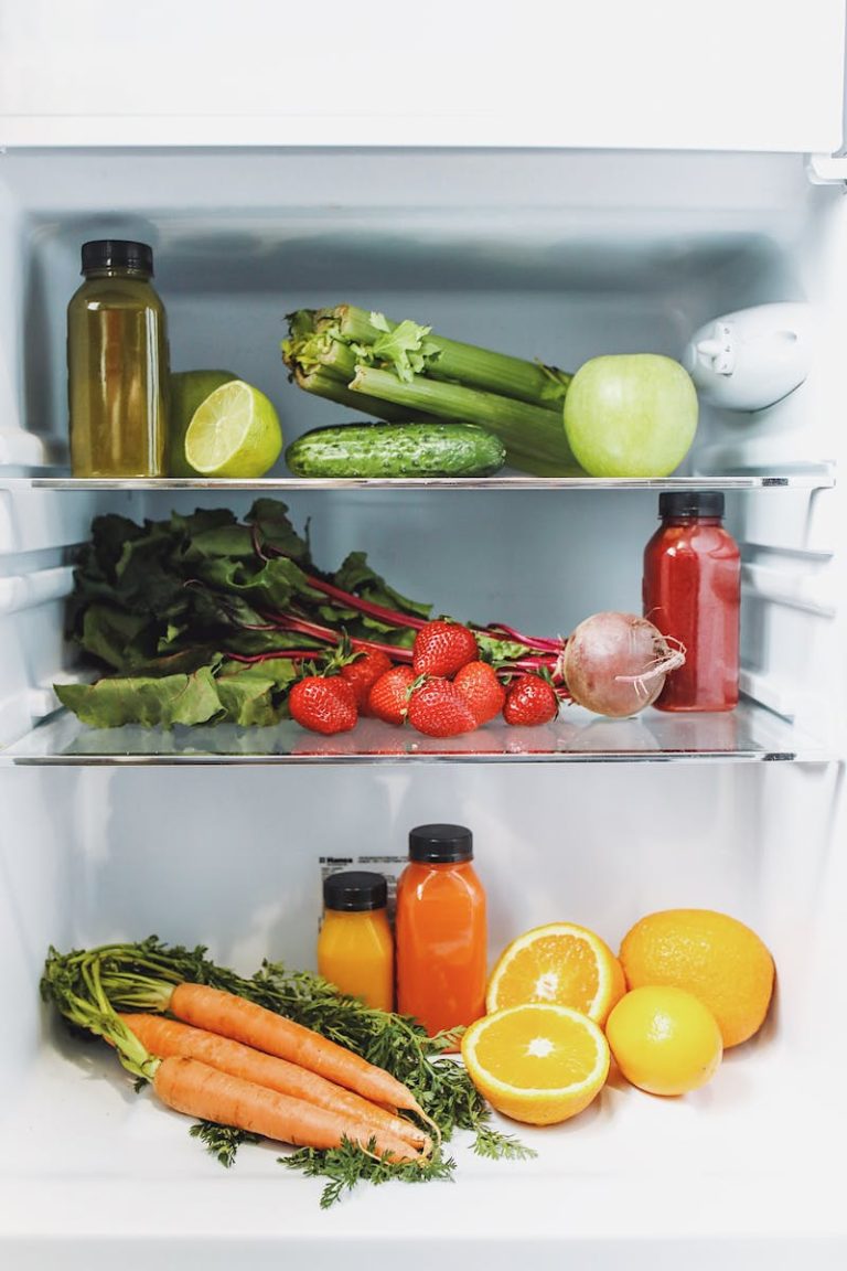 Variety of fresh fruits and vegetables in a refrigerator, vibrant and healthy.